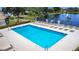 Community pool with lounge chairs and well-maintained landscaping, near a lake at 1021 Whalebone Bay Dr, Kissimmee, FL 34741