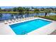 Community pool with lounge chairs and well-maintained landscaping at 1021 Whalebone Bay Dr, Kissimmee, FL 34741