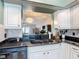 Kitchen sink with granite countertops, white cabinets and view of the living area at 1021 Whalebone Bay Dr, Kissimmee, FL 34741