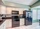 Well-lit kitchen featuring white cabinets, black appliances, and tile flooring at 1021 Whalebone Bay Dr, Kissimmee, FL 34741
