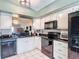 Modern kitchen with black appliances, granite countertops, and tile backsplash at 1021 Whalebone Bay Dr, Kissimmee, FL 34741