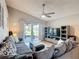 Comfortable living room with plush sofa, neutral tones, and sliding glass doors offering access to outdoor space at 1021 Whalebone Bay Dr, Kissimmee, FL 34741
