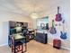 Versatile office featuring a desk, storage, guitars, and a pass-through to the kitchen, blending work and leisure at 1021 Whalebone Bay Dr, Kissimmee, FL 34741