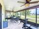 Screened in sunroom featuring patio furniture, exercise equipment, a ceiling fan, and a view of the yard at 1021 Whalebone Bay Dr, Kissimmee, FL 34741