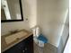 Bathroom with dark vanity and countertop plus a toilet with a protective cover at 1108 Bear Lake Rd, Apopka, FL 32703
