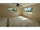 Bedroom featuring two windows and a ceiling fan. Floor coverings have been removed at 1108 Bear Lake Rd, Apopka, FL 32703