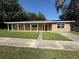 Charming single-story home featuring a covered porch and well-maintained lawn at 1108 Bear Lake Rd, Apopka, FL 32703