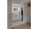 Bright bathroom with a modern vanity, illuminated mirror, and neutral tile flooring at 11137 Acme Dr # 207A, Orlando, FL 32825