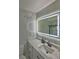 Contemporary bathroom showcasing a modern vanity, sink, and illuminated mirror at 11137 Acme Dr # 207A, Orlando, FL 32825