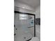 Bathroom featuring a glass enclosed shower, white marble, and patterned tile floors at 11137 Acme Dr # 207A, Orlando, FL 32825