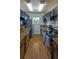 Galley kitchen featuring modern appliances, dark cabinets, and granite countertops at 11137 Acme Dr # 207A, Orlando, FL 32825