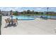 Community pool area with comfortable seating and shade umbrellas overlooking the lake at 11137 Acme Dr # 207A, Orlando, FL 32825