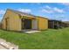 This backyard features a well-maintained lawn, a patio, and a covered porch at 12102 Sandal Creek Way, Orlando, FL 32824