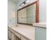 Bathroom with large mirror over vanity and storage cabinets below sink at 12102 Sandal Creek Way, Orlando, FL 32824