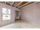 Bedroom featuring cement flooring, a window, and an exposed support beam for a closet at 12102 Sandal Creek Way, Orlando, FL 32824