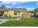 Inviting single-story home with a well-maintained lawn and a charming entrance in a sunny, residential area at 12102 Sandal Creek Way, Orlando, FL 32824