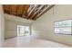 Spacious room with open beamed ceiling, large slider door, and plenty of natural light ready for renovation at 12102 Sandal Creek Way, Orlando, FL 32824