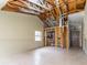 Spacious living room featuring tile flooring and an exposed ceiling with wooden support beams at 12102 Sandal Creek Way, Orlando, FL 32824