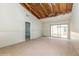 Large living room ready for renovation, featuring tiled floors and sliding doors to the backyard at 12102 Sandal Creek Way, Orlando, FL 32824