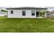 Newly constructed home with a lush lawn and sleek black trim windows at 13312 Sw 41St Ct, Ocala, FL 34473