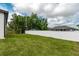 Large, fenced backyard featuring lush green grass and ample space for outdoor activities and privacy at 13312 Sw 41St Ct, Ocala, FL 34473