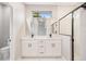 Sleek bathroom featuring a double vanity, glass-enclosed shower and modern finishes at 13312 Sw 41St Ct, Ocala, FL 34473