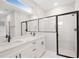 Well lit bathroom with a double vanity, glass shower, and modern fixtures at 13312 Sw 41St Ct, Ocala, FL 34473