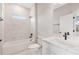Modern bathroom with marble tiled walls, a soaking tub, and sleek vanity at 13312 Sw 41St Ct, Ocala, FL 34473