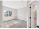 Light-filled bedroom featuring plush carpeting, a bright window, and access to a modern bathroom at 13312 Sw 41St Ct, Ocala, FL 34473