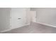 Bright bedroom with neutral carpet, double closet doors, and a view into the hallway at 13312 Sw 41St Ct, Ocala, FL 34473