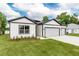 Well-manicured lawn accentuates this single-Gathering home with a two-car garage at 13312 Sw 41St Ct, Ocala, FL 34473