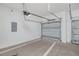 Clean three-car garage featuring overhead doors and ample unfinished wall space at 13312 Sw 41St Ct, Ocala, FL 34473