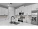 Close up of kitchen with stainless steel appliances, white cabinets, and large marble island at 13312 Sw 41St Ct, Ocala, FL 34473