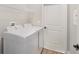 Functional laundry room with modern washer and dryer, shelving, and neutral flooring at 13312 Sw 41St Ct, Ocala, FL 34473