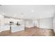 Bright, open-concept living room with modern kitchen, stainless appliances, and hardwood floors at 13312 Sw 41St Ct, Ocala, FL 34473
