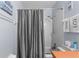 Bathroom shower/tub combo with gray shower curtain, a single sink vanity, and decor at 1333 Villa Ln # 47, Apopka, FL 32712