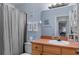 Bathroom with shower/tub combo, a single sink vanity, and decor at 1333 Villa Ln # 47, Apopka, FL 32712