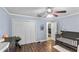 Spacious Bedroom with wood-look floors, featuring a crib and a large closet at 1333 Villa Ln # 47, Apopka, FL 32712