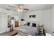 Bedroom with wood-look floors, ceiling fan, and en suite bath at 1333 Villa Ln # 47, Apopka, FL 32712