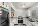 Modern kitchen with stainless steel appliances, granite countertops, and sleek cabinetry at 1333 Villa Ln # 47, Apopka, FL 32712