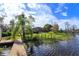 Lush backyard leading to a serene lake, complemented by a private dock and beautiful landscaping at 13377 Lake Butler Blvd, Winter Garden, FL 34787