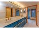Bathroom featuring double sinks, large mirrors, and tiled floors at 13377 Lake Butler Blvd, Winter Garden, FL 34787
