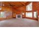 Comfortable living room featuring a fireplace, built-in shelving, and serene views from large windows at 13377 Lake Butler Blvd, Winter Garden, FL 34787