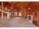 Large living space with a fireplace, a unique spiral staircase and wood-paneled walls and vaulted ceiling at 13377 Lake Butler Blvd, Winter Garden, FL 34787