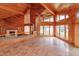 Cozy living room with wood paneling, and large windows overlooking the picturesque outdoor scenery at 13377 Lake Butler Blvd, Winter Garden, FL 34787