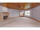 Large living room with a fireplace, carpet, and view of the water and pool at 13377 Lake Butler Blvd, Winter Garden, FL 34787