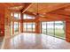 Bright sunroom featuring wood-paneled walls and ceilings, tile floors, and expansive lake views at 13377 Lake Butler Blvd, Winter Garden, FL 34787