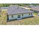 This aerial view showcases a home's back exterior with a sliding glass door and gray shingle roof at 13430 Sw 88Th Ter, Ocala, FL 34473