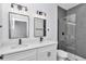 Bathroom boasts double vanity with quartz countertop, matte black fixtures, and glass-enclosed shower with gray tiling at 13430 Sw 88Th Ter, Ocala, FL 34473