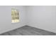 Bedroom featuring wood floors, neutral walls, a window, and base trim at 13430 Sw 88Th Ter, Ocala, FL 34473